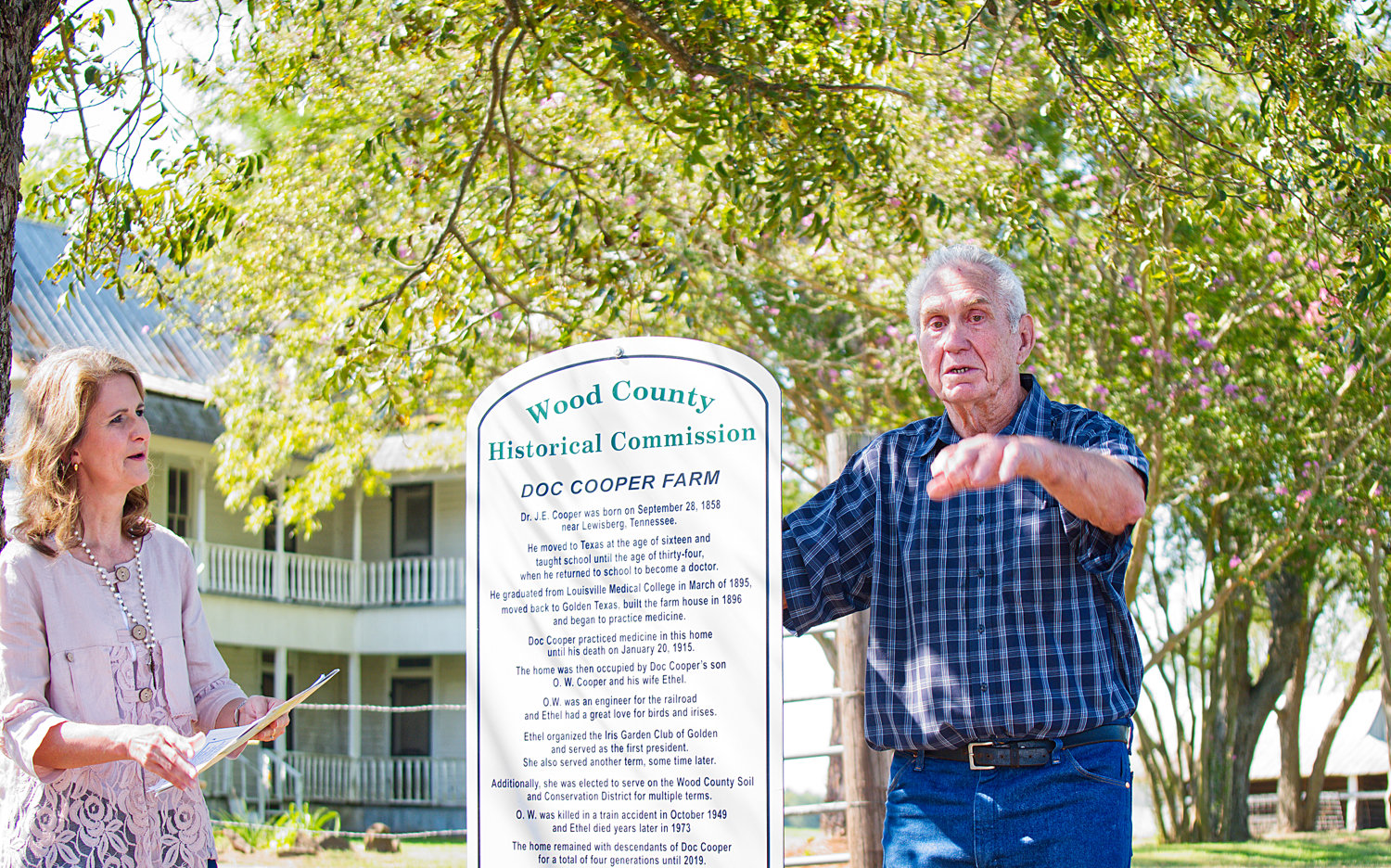 At last week’s dedication of the Wood County historical marker at the Doc Cooper Farm, County Judge Lucy Hebron listens as Don Shamburger recalls stories of the old home.